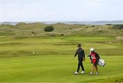 18 July 2019; Brooks Koepka of USA with his caddy Ricky Elliott on their way to the 16th green during Day One of the 148th Open Championship at Royal Portrush in Portrush, Co Antrim. Photo by Ramsey Cardy/Sportsfile