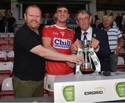18 July 2019; Cork captain Peter O'Driscoll is presented with the cup by EirGrid Community Officer Eoghan O’Sullivan, left, and Munster Council Chairman Liam Lenihan following the EirGrid Munster GAA Football U20 Championship Final match between Cork and Kerry at Páirc Ui Rinn in Cork. Photo by Matt Browne/Sportsfile
