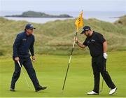 19 July 2019; Shane Lowry of Ireland puts the flag back in the 16th hole after Phil Mickelson of USA makes a putt during Day Two of the 148th Open Championship at Royal Portrush in Portrush, Co Antrim. Photo by Ramsey Cardy/Sportsfile