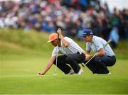 21 July 2019; Rickie Fowler of USA, left, and Justin Rose of England line up putts on the 18th green during Day Four of the 148th Open Championship at Royal Portrush in Portrush, Co Antrim. Photo by Ramsey Cardy/Sportsfile