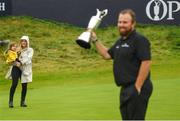 21 July 2019; Shane Lowry of Ireland celebrates with the Claret Jug after winning The Open Championship as his wife Wendy Honner and daughter Iris watch on, on Day Four of the 148th Open Championship at Royal Portrush in Portrush, Co Antrim. Photo by Ramsey Cardy/Sportsfile