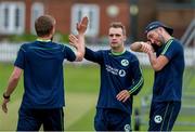 22 July 2019; Andy McBrine (centre) high fives teammates after a football match during an Ireland Cricket training session at Lords Cricket Ground in London, England. Photo by Matt Impey/Sportsfile
