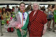 22 July 2019; Sarah Healy, silver medal winner from the Women's 1500m event, is presented with flowers by President of Athletics Ireland Georgina Drumm on the return home of Team Ireland from the European Athletics U20 Athletics Championships at Dublin Airport. Photo by Piaras Ó Mídheach/Sportsfile