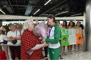 22 July 2019; Kate O’Connor, silver medal winner from the Women's Heptathlon event, is presented with flowers by President of Athletics Ireland Georgina Drumm on the return home of Team Ireland from the European Athletics U20 Athletics Championships at Dublin Airport. Photo by Piaras Ó Mídheach/Sportsfile