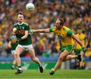21 July 2019; Tom O'Sullivan of Kerry punch passes the ball clear of Michael Murphy of Donegal during the GAA Football All-Ireland Senior Championship Quarter-Final Group 1 Phase 2 match between Kerry and Donegal at Croke Park in Dublin. Photo by Ray McManus/Sportsfile
