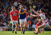 23 July 2019; Kian O'Kelly of Tipperary shoots to score their side’s second goal, despite the attentions of Ger Collins, right, and Daire Connery of Cork, during the Bord Gais Energy Munster GAA Hurling Under 20 Championship Final match between Tipperary and Cork at Semple Stadium in Thurles, Co Tipperary. Photo by Sam Barnes/Sportsfile