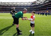 28 July 2019; NLI volunteer lifeboat crew from stations across Ireland unfurl giant water safety flags on the pitch of Croke Park before the All-Ireland Senior Hurling semi-final between Wexford and Tipperary.  The activity was part of the RNLI’s partnership with the GAA to prevent drownings and share water safety advice.  10 year old Cahir MCallion, from Omagh, Co. Tyrone, who was rescued from the sea at Bundoran last year presents the sliothar to referee Sean Cleere prior to the GAA All-Ireland Senior Hurling semi-final in Croke Park as part of the RNLI’s partnership with the GAA to prevent drownings and share water safety advice. Photo by Ramsey Cardy/Sportsfile