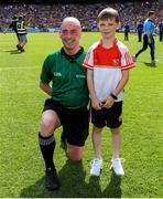 28 July 2019; NLI volunteer lifeboat crew from stations across Ireland unfurl giant water safety flags on the pitch of Croke Park before the All-Ireland Senior Hurling semi-final between Wexford and Tipperary.  The activity was part of the RNLI’s partnership with the GAA to prevent drownings and share water safety advice.  10 year old Cahir MCallion, from Omagh, Co. Tyrone, who was rescued from the sea at Bundoran last year presents the sliothar to referee Sean Cleere prior to the GAA All-Ireland Senior Hurling semi-final in Croke Park as part of the RNLI’s partnership with the GAA to prevent drownings and share water safety advice. Photo by Ramsey Cardy/Sportsfile