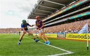 28 July 2019; Paul Morris of Wexford puts the sliotar through the legs of Cathal Barrett of Tipperary before going on to score a point during the GAA Hurling All-Ireland Senior Championship Semi Final match between Wexford and Tipperary at Croke Park in Dublin. Photo by Brendan Moran/Sportsfile