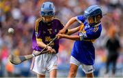 28 July 2019; Alfie Hughes, Annyalla NS, Castleblayney, Monaghan, representing Tipperary, in action against Matthew O'Neill, Carnaun NS, Athenry, Galway, representing Wexford,  during the INTO Cumann na mBunscol GAA Respect Exhibition Go Games at the GAA Hurling All-Ireland Senior Championship Semi Final match between Wexford and Tipperary at Croke Park in Dublin. Photo by Brendan Moran/Sportsfile