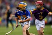28 July 2019; Catríona McKinney, St Mura’s NS, Burnfoot, Donegal, representing Tipperary, in action against Saoirse D’Arcy, Scoil Mhuire na nGael , Dundalk, Louth, representing Wexford, during the INTO Cumann na mBunscol GAA Respect Exhibition Go Games at the GAA Hurling All-Ireland Senior Championship Semi Final match between Wexford and Tipperary at Croke Park in Dublin. Photo by Ramsey Cardy/Sportsfile