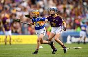 28 July 2019; Catríona McKinney, St Mura’s NS, Burnfoot, Donegal, representing Tipperary, in action against Molly Conroy, St Aidan’s NS, Kilmanagh , Kilkenny, representing Wexford, during the INTO Cumann na mBunscol GAA Respect Exhibition Go Games at the GAA Hurling All-Ireland Senior Championship Semi Final match between Wexford and Tipperary at Croke Park in Dublin. Photo by Ramsey Cardy/Sportsfile