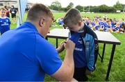 31 July 2019; Leinster player James Tracy signs autographs for participants during the Bank of Ireland Leinster Rugby Summer Camp at Coolmine RFC in Castleknock, Dublin. Photo by Brendan Moran/Sportsfile