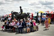 1 August 2019; Racegoers study the form prior to racing on Day Four of the Galway Races Summer Festival 2019 in Ballybrit, Galway. Photo by Seb Daly/Sportsfile
