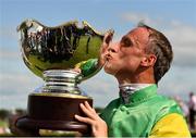 1 August 2019; Jockey Robbie Power celebrates with the trophy after riding Tudor City to victory in the Guinness Galway Hurdle Handicap on Day Four of the Galway Races Summer Festival 2019 in Ballybrit, Galway. Photo by Seb Daly/Sportsfile