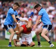 4 August 2019; Michael McKernan of Tyrone is tackled by Cian O'Connor, left, and Robert McDaid of Dublin during the GAA Football All-Ireland Senior Championship Quarter-Final Group 2 Phase 3 match between Tyrone and Dublin at Healy Park in Omagh, Tyrone. Photo by Brendan Moran/Sportsfile