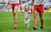 11 August 2019; Chloe Cavanagh, daughter of Colm Cavanagh of Tyrone, leaves the pitch with her father and his team-mate Michael McKernan after the GAA Football All-Ireland Senior Championship Semi-Final match between Kerry and Tyrone at Croke Park in Dublin. Photo by Brendan Moran/Sportsfile