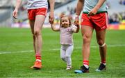 11 August 2019; Chloe Cavanagh, daughter of Colm Cavanagh of Tyrone, leaves the pitch with her father and his team-mate Michael McKernan after the GAA Football All-Ireland Senior Championship Semi-Final match between Kerry and Tyrone at Croke Park in Dublin. Photo by Brendan Moran/Sportsfile