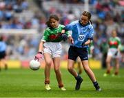 10 August 2019; Aisling McWeeney, Drumcong NS, Drumcong, Leitrim, representing Mayo, in action against Maggie Holland, Rampark NS, Dundalk, Louth, representing Dublin, during the INTO Cumann na mBunscol GAA Respect Exhibition Go Games during the GAA Football All-Ireland Senior Championship Semi-Final match between Dublin and Mayo at Croke Park in Dublin. Photo by Ray McManus/Sportsfile