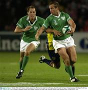 11 October 2003; Keith Gleeson, Ireland, prepares to offload to team-mate Girvan Dempsey, despte the tackle of George Chirac, Romania. 2003 Rugby World Cup, Pool A, Ireland v Romania, Central Coast Stadium, Gosford, New South Wales, Australia. Picture credit; Brendan Moran / SPORTSFILE *EDI*