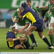 11 October 2003; Victor Costello, Ireland, in action against Romeo Gontineac, left, and George Chirac, Romania. 2003 Rugby World Cup, Pool A, Ireland v Romania, Central Coast Stadium, Gosford, New South Wales, Australia. Picture credit; Brendan Moran / SPORTSFILE *EDI*