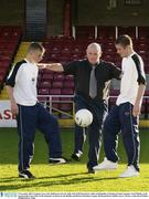 9 November 2003; Graham Carey, left, Shelbourne tests his skills with Niall Fitzmaurice, right, and Republic of Ireland assistant manager Noel O'Reilly, at the launch of the Tayto EOLAS Development Academy by the Dublin and District Schoolboy League. Richmond Park, Dublin. Soccer. Picture credit; David Maher / SPORTSFILE *EDI*