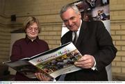 10 November 2003; An Taoiseach Bertie Ahern T.D. in the company of Team Ireland Special Olympics athlete Catriona Ryan looks through Midsummer Magic before it's launch. Bank of Ireland, House of Lords, Dublin. Picture credit; Pat Murphy / SPORTSFILE *EDI*