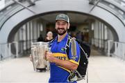 16 August 2019; Tipperary supporter Matt Shelbourne, from New York, with the Liam MacCarthy Cup at the GAA’s Home for the Match stand in the arrivals hall at Dublin Airport. Photo by Ramsey Cardy/Sportsfile