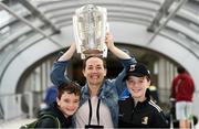 16 August 2019; Róisín Fox with her sons 9 year old Darragh, left, and 11 year old Cian, from Kilkenny City, with the Liam MacCarthy Cup at the GAA’s Home for the Match stand in the arrivals hall at Dublin Airport. Photo by Ramsey Cardy/Sportsfile