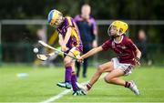 17 August 2019; Colm Ryan of Newport, Co Tipperary in action against Joe Dowling of Dicksboro, Co Kilkenny in the Hurling U11 Boys A final during Day 1 of the Aldi Community Games August Festival, which saw over 3,000 children take part in a fun-filled weekend at UL Sports Arena in University of Limerick, Limerick. Photo by David Fitzgerald/Sportsfile