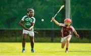 17 August 2019; Habeeb Olatokumbo of Ballincollig, Co Cork in action against Josh Dowling of Dicksboro, Co Kilkenny in the Hurling U11 Boys A semi-final during Day 1 of the Aldi Community Games August Festival, which saw over 3,000 children take part in a fun-filled weekend at UL Sports Arena in University of Limerick, Limerick. Photo by David Fitzgerald/Sportsfile
