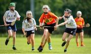 17 August 2019; Sarah Corcoran of Moycarkey-Borris, Co Tipperary in action against Mikayla Noone of Bullaun-New Inn of Co Galway in the U14 Camogie semi-final during Day 1 of the Aldi Community Games August Festival, which saw over 3,000 children take part in a fun-filled weekend at UL Sports Arena in University of Limerick, Limerick. Photo by David Fitzgerald/Sportsfile