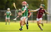 17 August 2019; Eanna Lynch of Ballincollig, Co Cork in action against Robert Lacey of Dicksboro, Co Kilkenny in the U11 hurling semi-final during Day 1 of the Aldi Community Games August Festival, which saw over 3,000 children take part in a fun-filled weekend at UL Sports Arena in University of Limerick, Limerick. Photo by David Fitzgerald/Sportsfile