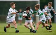 18 August 2019; Evan Stack of Ballincollig, Co. Cork, is tackled by Oisin, left, and Fiach Silke of Moycullen, Co. Galway, during the Boys/Girls/Mixed U10 Gaelic Football during Day 2 of the Aldi Community Games August  Festival, which saw over 3,000 children take part in a fun-filled weekend at UL Sports Arena in University of Limerick, Limerick. Photo by Ben McShane/Sportsfile