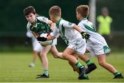 18 August 2019; Evan Stack of Ballincollig, Co. Cork, is tackled by Oisin, centre, and Fiach Silke of Moycullen, Co. Galway, during the Boys/Girls/Mixed U10 Gaelic Football during Day 2 of the Aldi Community Games August  Festival, which saw over 3,000 children take part in a fun-filled weekend at UL Sports Arena in University of Limerick, Limerick. Photo by Ben McShane/Sportsfile