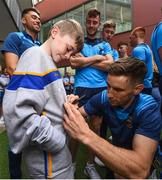 19 August 2019; John O’Dwyer of Tipperary signs an autograph for  Harry Tutty, aged 9, from Gorey, Co. Wexford, on a visit by the Tipperary All-Ireland hurling champions to Children's Health Ireland at Crumlin in Dublin.  Photo by Sam Barnes/Sportsfile