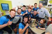 19 August 2019; Charlie Aabo, and his son Kian Barnes-Aabo, aged 5, from Glanmire, Co. Cork, are shown the Liam MacCarthy cup by Tipperary manager Liam Sheedy and Tipperary players on a visit by the Tipperary All-Ireland hurling champions to Children's Health Ireland at Crumlin in Dublin.  Photo by Sam Barnes/Sportsfile