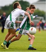 18 August 2019; Eoin Harris of Ballincollig, Co. Cork, is tackled by Nicky Faherty of Moycullen, Co. Galway, as he shoots to score his side's first goal while competing in the U10 Boys/Girls/Mixed Gaelic Football during Day 2 of the Aldi Community Games August Festival, which saw over 3,000 children take part in a fun-filled weekend at UL Sports Arena in University of Limerick, Limerick. Photo by Ben McShane/Sportsfile