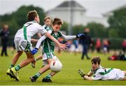 18 August 2019; Eoin Harris of Ballincollig, Co. Cork, is tackled by Nicky Faherty of Moycullen, Co. Galway, as he shoots to score his side's first goal while competing in the U10 Boys/Girls/Mixed Gaelic Football during Day 2 of the Aldi Community Games August Festival, which saw over 3,000 children take part in a fun-filled weekend at UL Sports Arena in University of Limerick, Limerick. Photo by Ben McShane/Sportsfile