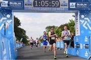 24 August 2019; Runners cross the finish line after competing in the KBC & Dublin Marathon Race Series, where, over 5,200 runners took part in the Frank Duffy 10 Mile, part of the KBC Dublin Race Series 2019 at Phoenix Park in Dublin. Photo by Sam Barnes/Sportsfile