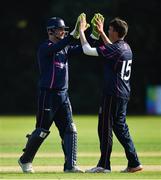 25 August 2019; Jacob Mulder of CIYMS, right, is congratulated by team-mate Chris Dougherty after claiming the wicket of Gregory Ford of Malahide during the All-Ireland T20 Cricket Final match between CIYMS and Malahide at Stormont in Belfast. Photo by Seb Daly/Sportsfile