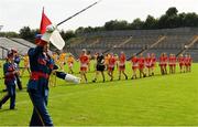 24 August 2019; The Louth and Antrim players march behind members of  the Artane Band during the parade before the TG4 All-Ireland Ladies Football Junior Championship Semi-Final match between Louth and Antrim at St Tiernach's Park in Clones, Monaghan. Photo by Ray McManus/Sportsfile