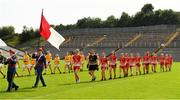 24 August 2019; The Louth and Antrim players march behind members of  the Artane Band during the parade before the TG4 All-Ireland Ladies Football Junior Championship Semi-Final match between Louth and Antrim at St Tiernach's Park in Clones, Monaghan. Photo by Ray McManus/Sportsfile