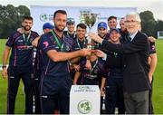 25 August 2019; CIYMS captain Nigel Jones is presented with the trophy by Cricket Ireland President David O'Connor following his side's victory during the All-Ireland T20 Cricket Final match between CIYMS and Malahide at Stormont in Belfast. Photo by Seb Daly/Sportsfile