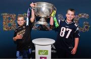 30 August 2019; 10 year old Charlie O'Connor, left, and 11 year old Ken Jr. O'Connor, right, from Glencar, Co. Kerry, back from New York to watch the All-Ireland Final, with the Sam Maguire Cup at the GAA’s Home for the Match stand in the arrivals hall at Dublin Airport. Photo by Matt Browne/Sportsfile