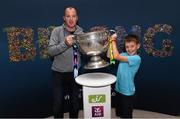 30 August 2019; Graham Smith from Co. Galway and his son Eoghan, age 11, with the Sam Maguire Cup at the GAA’s Home for the Match stand in the arrivals hall at Dublin Airport. Photo by Matt Browne/Sportsfile
