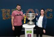 30 August 2019; Jamie O'Connor and Katie Lane from Limerick with the Sam Maguire Cup at the GAA’s Home for the Match stand in the arrivals hall at Dublin Airport. Photo by Matt Browne/Sportsfile