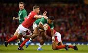 31 August 2019; Bundee Aki of Ireland is tackled by Scott Williams, left, and Jarrod Evans of Wales during the Under Armour Summer Series 2019 match between Wales and Ireland at the Principality Stadium in Cardiff, Wales. Photo by Brendan Moran/Sportsfile