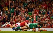31 August 2019; Jacob Stockdale of Ireland scores his side's second try despite the tackle of Hallam Amos of Wales during the Under Armour Summer Series 2019 match between Wales and Ireland at the Principality Stadium in Cardiff, Wales. Photo by Brendan Moran/Sportsfile