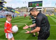 1 September 2019; Referee Noel Mooney is presented with the match ball by Gearóid Linehan, Ballyhass NS, Castlemagner, Co, Cork, before the Electric Ireland GAA Football All-Ireland Minor Championship Final match between Cork and Galway at Croke Park in Dublin. Photo by Piaras Ó Mídheach/Sportsfile